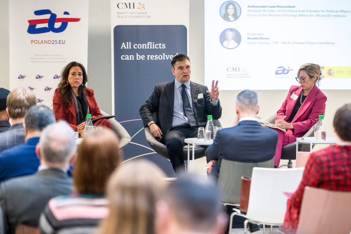 Speakers at the Brussels event sitting in front of the crowd.