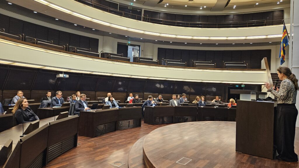 People sitting at the Åland Parliament building