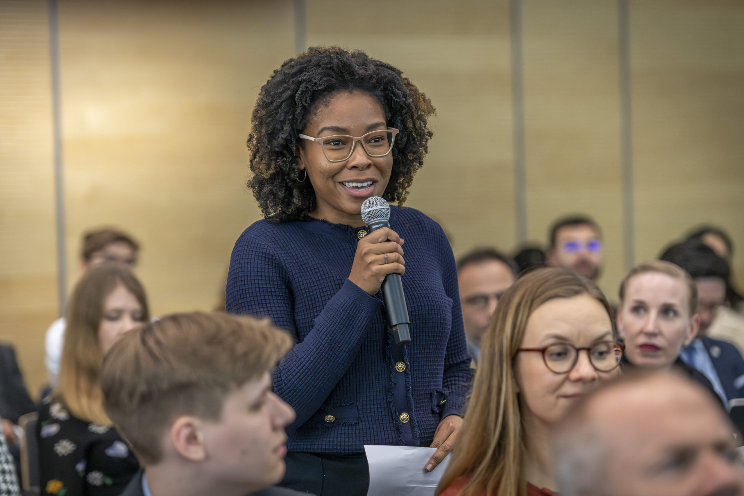 A woman asking a question from the audience.