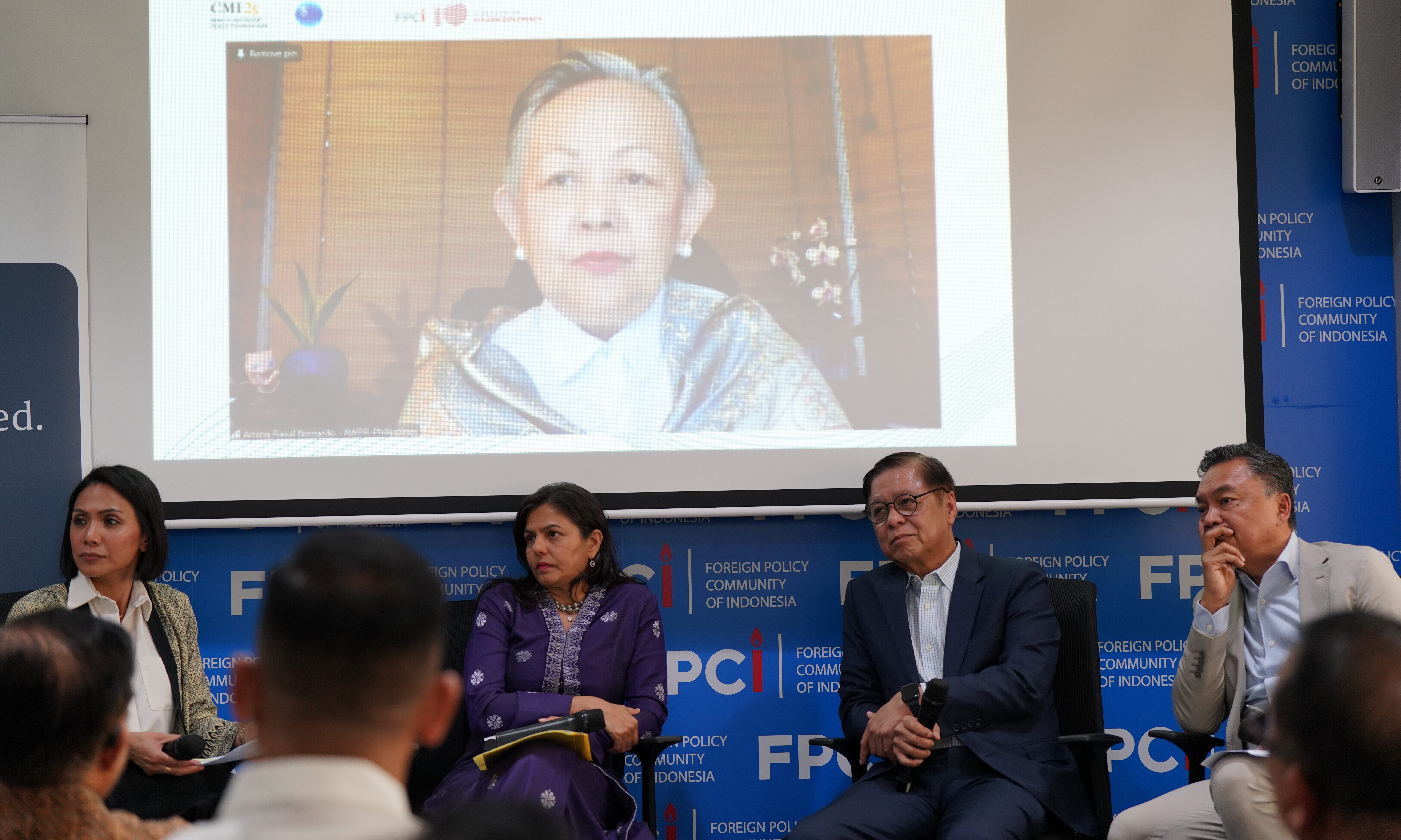 A panel discussion, three panellists and a moderator.