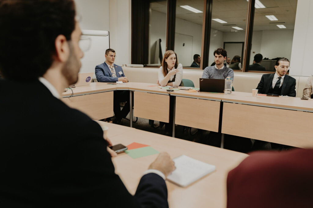 Participants seated at a table during the YPS Conference and week in Brussels.
