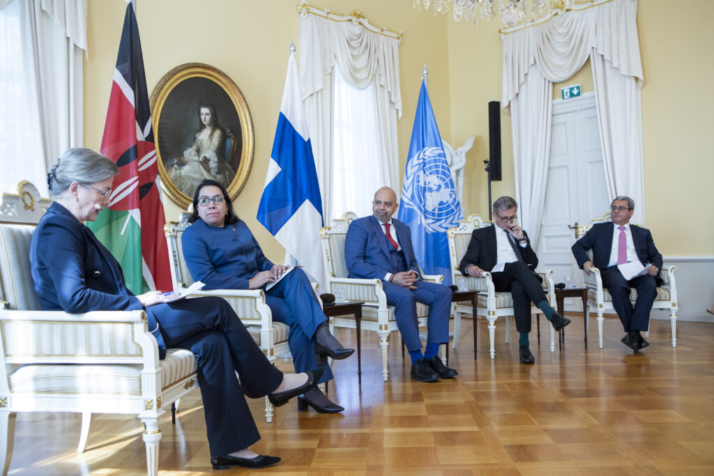A panel discussion with 5 people sitting 